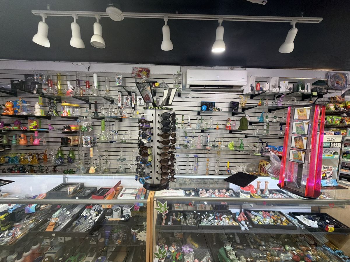 Inside 420 Smoke Shop: lit glass display cases
